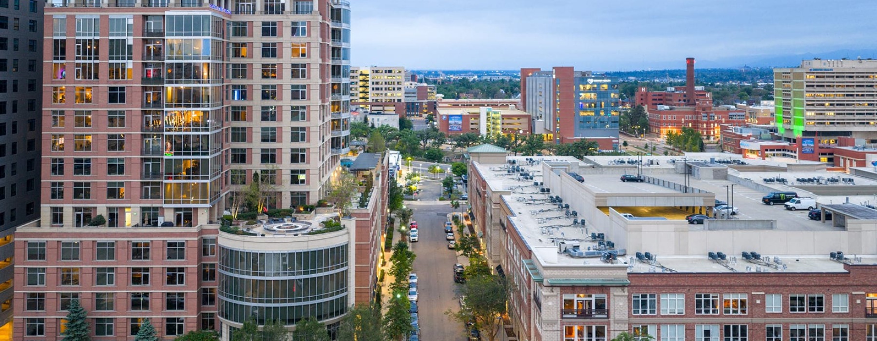 city with building and a street with cars on it