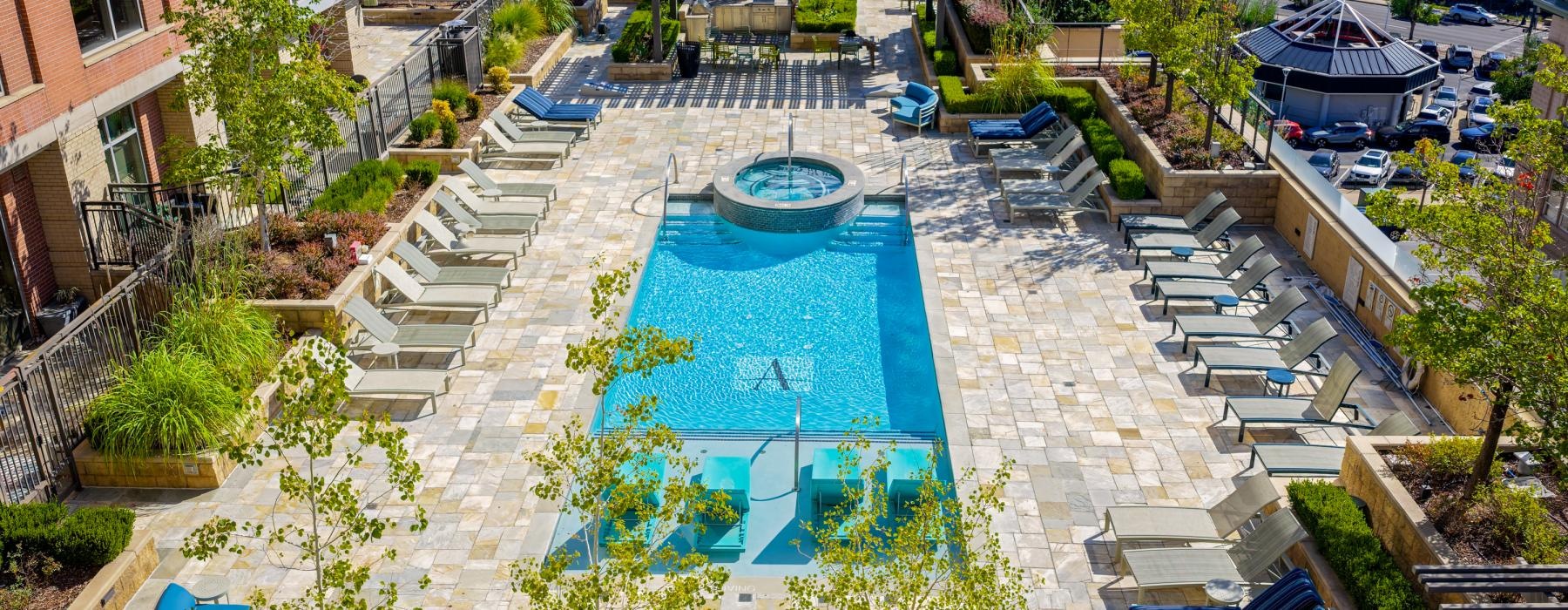 Resort-style swimming pool with lounge seating