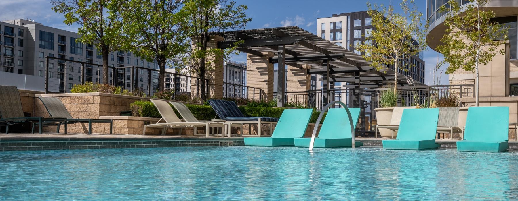 Resort-style swimming pool with lounge seating
